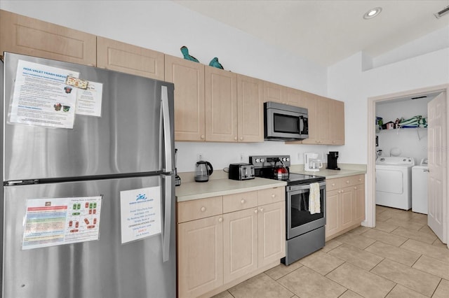 kitchen featuring washer and clothes dryer, stainless steel appliances, visible vents, light countertops, and light brown cabinets