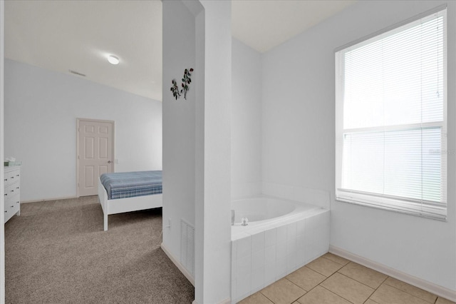 ensuite bathroom with baseboards, ensuite bath, tile patterned floors, vanity, and a bath