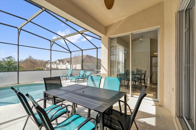 view of patio featuring glass enclosure, an outdoor pool, and outdoor dining space