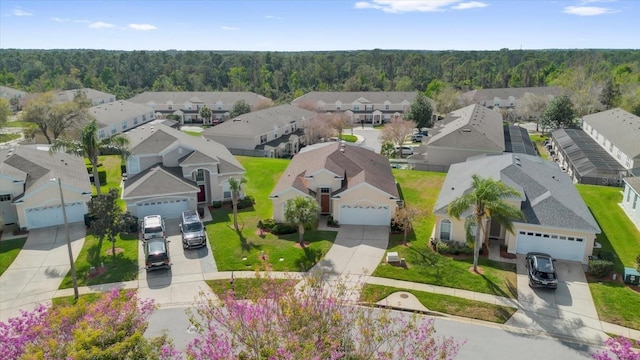 birds eye view of property featuring a residential view and a view of trees