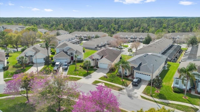 birds eye view of property featuring a residential view and a forest view