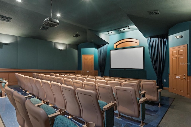 home theater room featuring visible vents and a textured ceiling