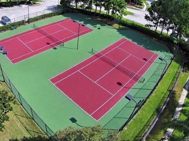 view of sport court featuring fence