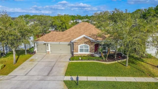 ranch-style house with a garage, concrete driveway, a front lawn, and a shingled roof