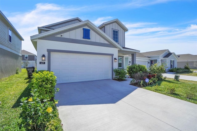 view of front of house with concrete driveway, a front lawn, board and batten siding, and an attached garage