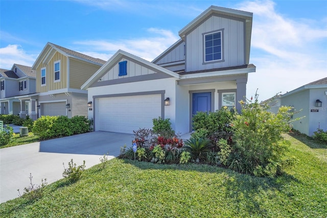 view of front of house with an attached garage, a front lawn, board and batten siding, and concrete driveway