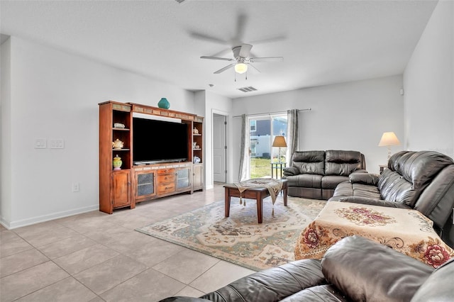 living area with baseboards, visible vents, a ceiling fan, and light tile patterned flooring