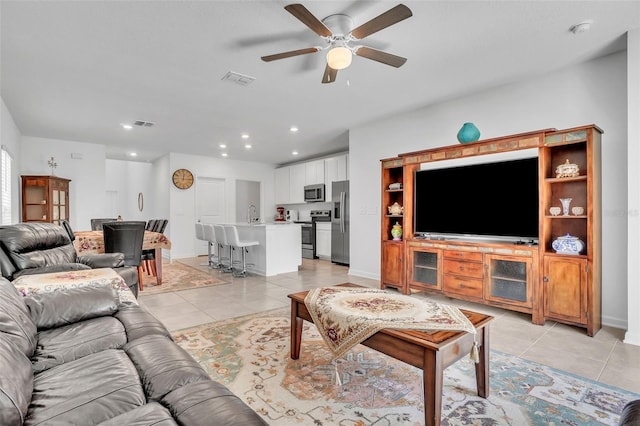 living area featuring baseboards, visible vents, a ceiling fan, light tile patterned flooring, and recessed lighting