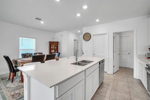 kitchen with appliances with stainless steel finishes, light countertops, visible vents, and a sink