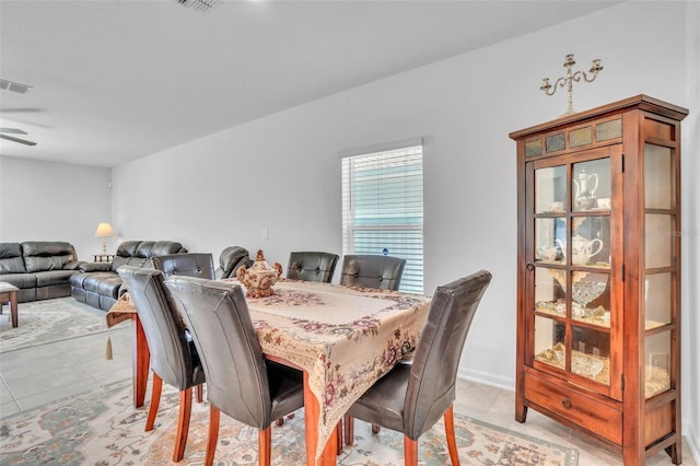 dining room featuring a ceiling fan, light tile patterned flooring, and visible vents