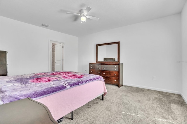 carpeted bedroom featuring baseboards, visible vents, and a ceiling fan