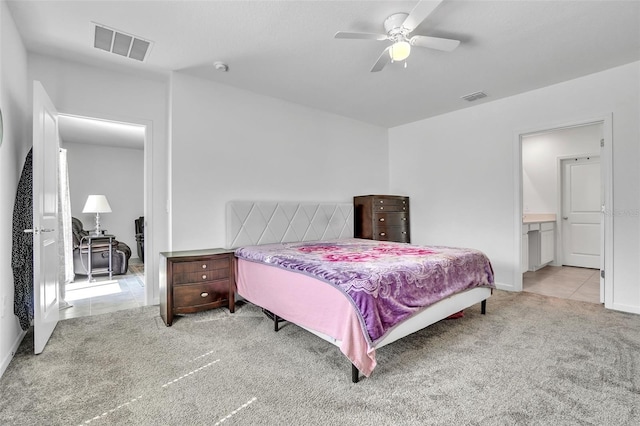 carpeted bedroom featuring ceiling fan, visible vents, and tile patterned floors