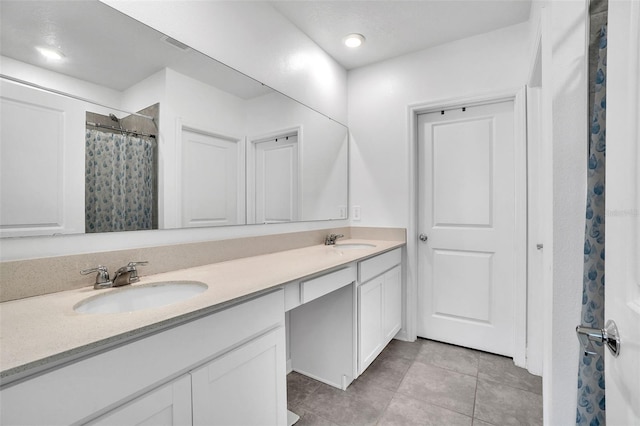 bathroom with double vanity, tile patterned flooring, a sink, and a shower with curtain