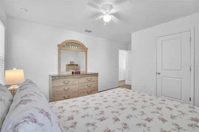 carpeted bedroom with visible vents and a ceiling fan