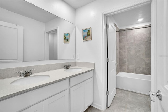 full bathroom with double vanity, a sink, and washtub / shower combination