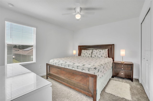 bedroom featuring baseboards, carpet, a ceiling fan, and a closet