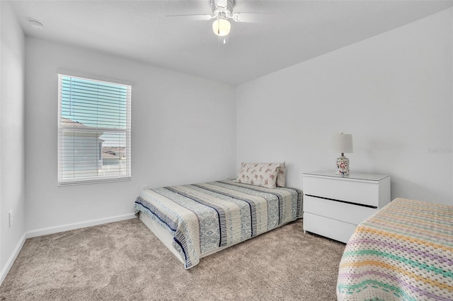 bedroom featuring carpet floors, baseboards, and a ceiling fan