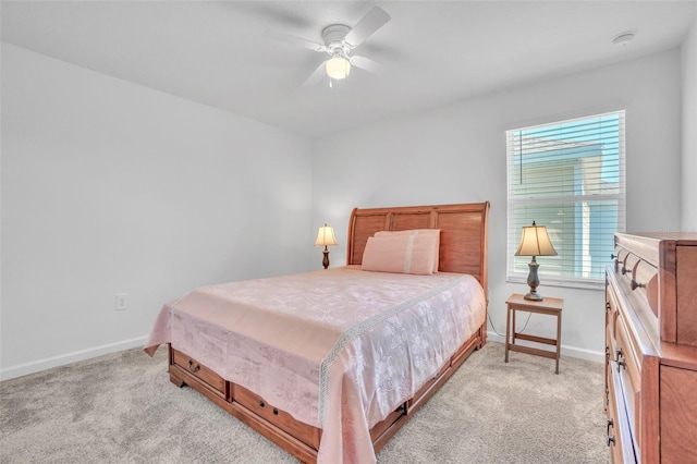 bedroom featuring light carpet, multiple windows, and baseboards