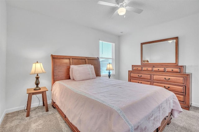 bedroom with light carpet, a ceiling fan, and baseboards