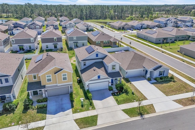 aerial view featuring a residential view and a wooded view