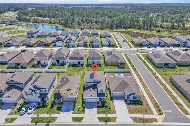 bird's eye view with a water view, a residential view, and a view of trees