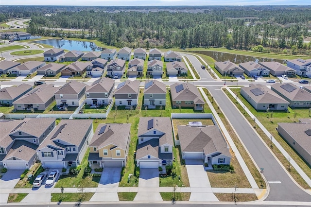 drone / aerial view featuring a water view and a residential view