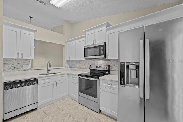 kitchen featuring white cabinetry, appliances with stainless steel finishes, light countertops, and a sink