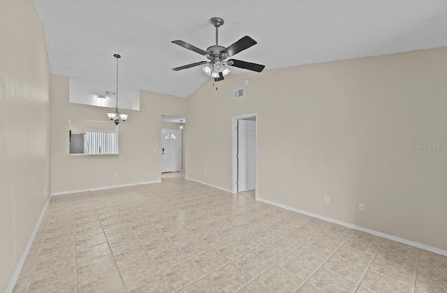 empty room with light tile patterned floors, baseboards, visible vents, vaulted ceiling, and ceiling fan with notable chandelier