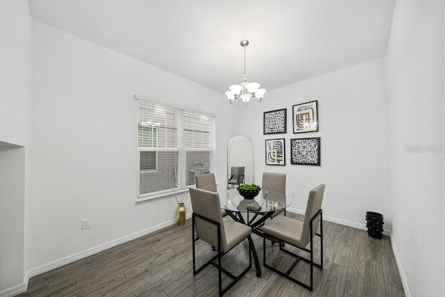 dining room with dark wood-style floors, baseboards, and a chandelier