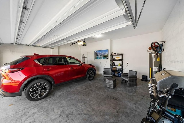 garage featuring water heater and a garage door opener