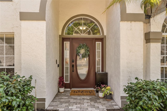 property entrance with stucco siding