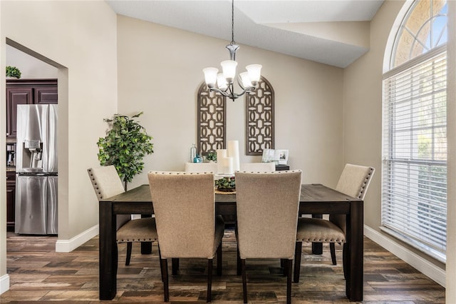 dining room with dark wood-type flooring, baseboards, lofted ceiling, and a chandelier