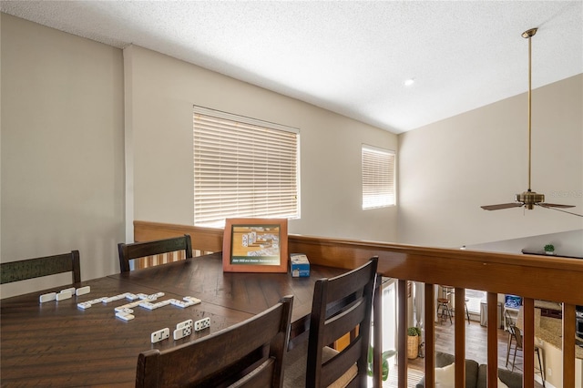 dining room featuring a textured ceiling and ceiling fan