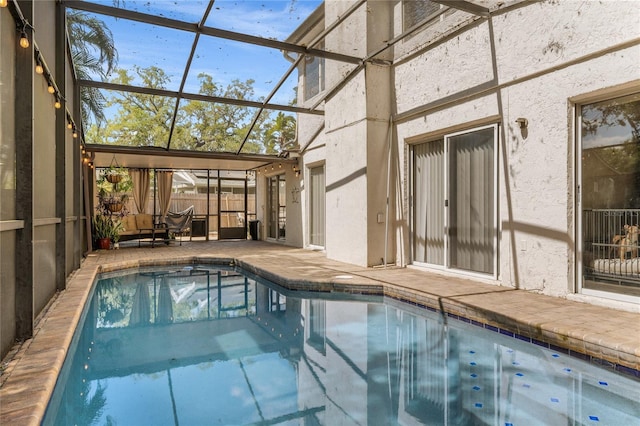 pool with glass enclosure and a patio