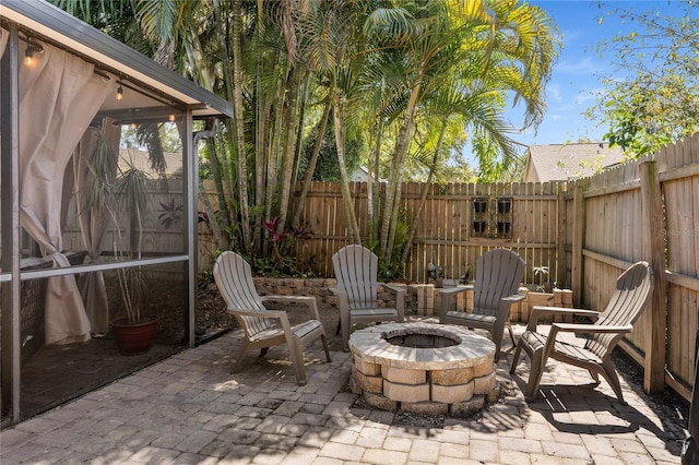 view of patio / terrace with a fenced backyard and a fire pit