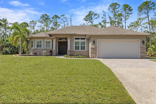 view of front facade with a front yard, concrete driveway, and stucco siding