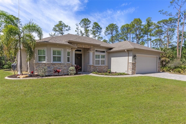 prairie-style house featuring a garage, a front yard, decorative driveway, and stucco siding