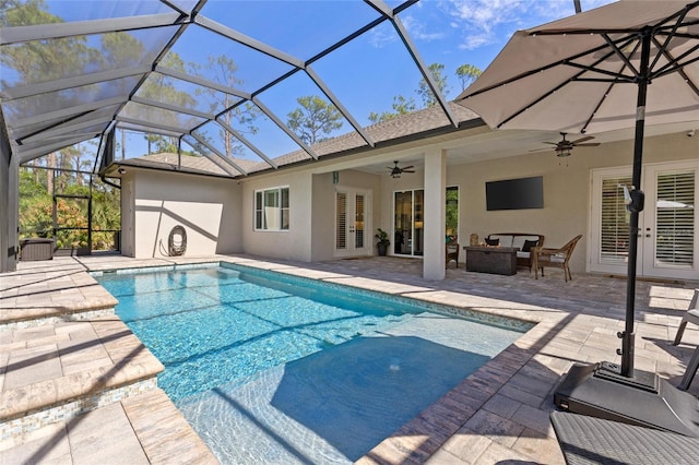 outdoor pool with ceiling fan, outdoor lounge area, a patio, and french doors