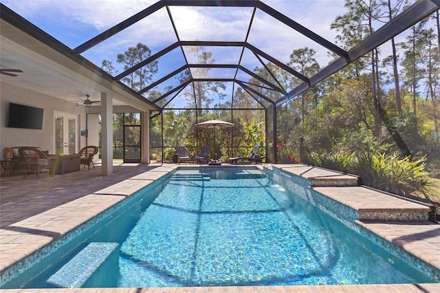 pool featuring ceiling fan, glass enclosure, french doors, and a patio area