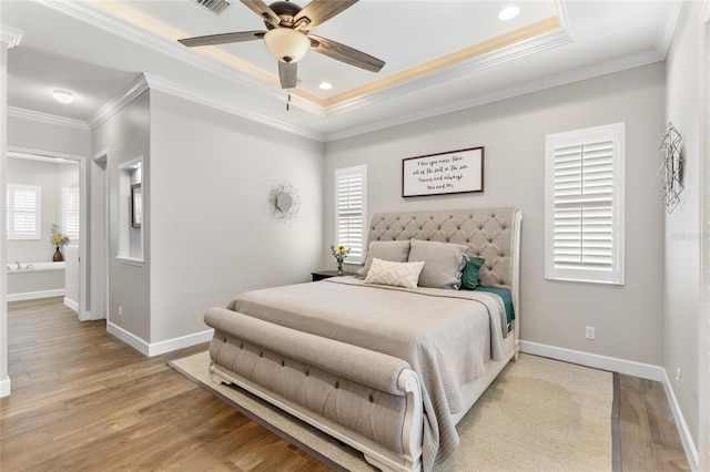 bedroom with light wood-style flooring, multiple windows, baseboards, and ornamental molding