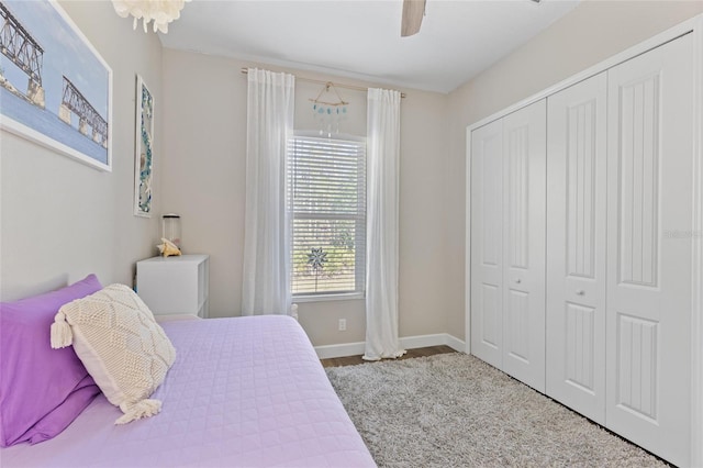 bedroom with ceiling fan, a closet, and baseboards