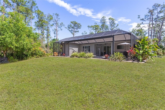 rear view of house with a yard and a lanai