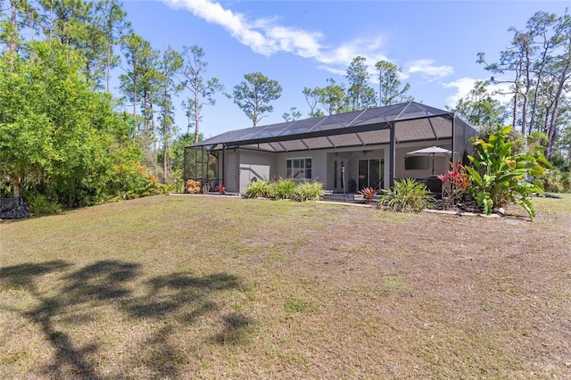 rear view of property featuring glass enclosure, a yard, and a patio