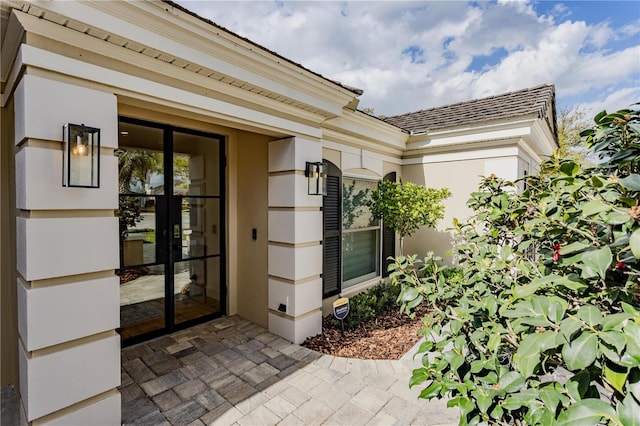 property entrance featuring stucco siding