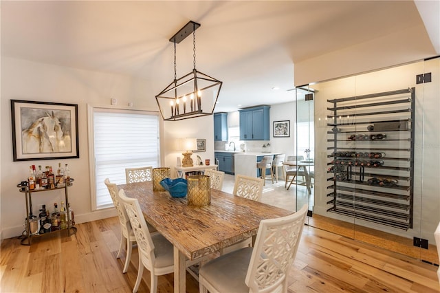 dining area featuring a chandelier and light wood-style flooring