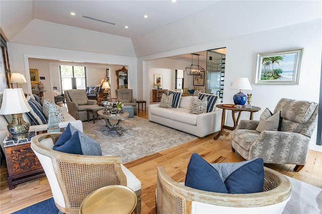 living area featuring a chandelier, visible vents, recessed lighting, and wood finished floors