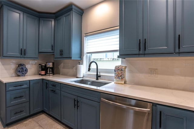 kitchen featuring a sink, backsplash, stainless steel dishwasher, and light tile patterned flooring