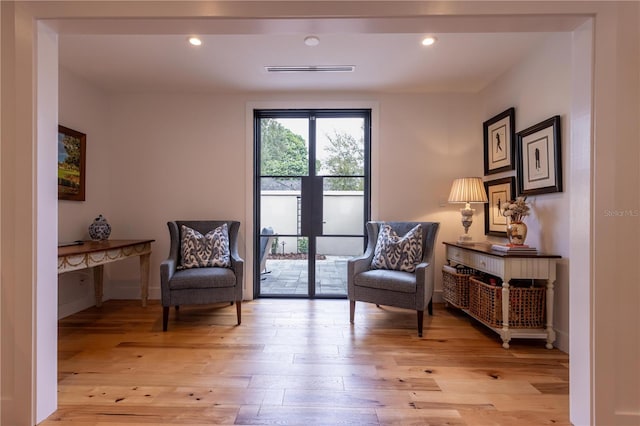 sitting room with recessed lighting, light wood-style flooring, and visible vents