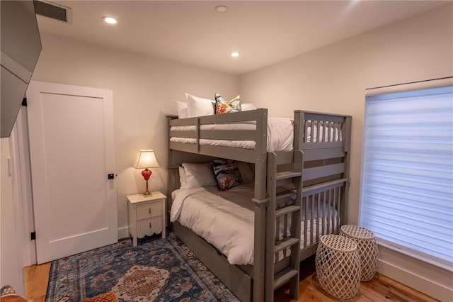 bedroom featuring visible vents, recessed lighting, baseboards, and wood finished floors