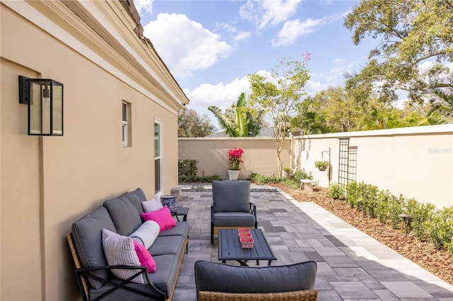 view of patio / terrace with an outdoor hangout area and fence